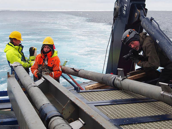 Björn Eriksson documenting sediment coring procedures. The stainless steel devices mounted on the core barrel are holders from temperature probes used to measure the temperature of the Arctic Ocean sediments with. Sediment temperature is one of the critical parameters for numerical modeling of the stability of gas hydrates in slope sediments. 
